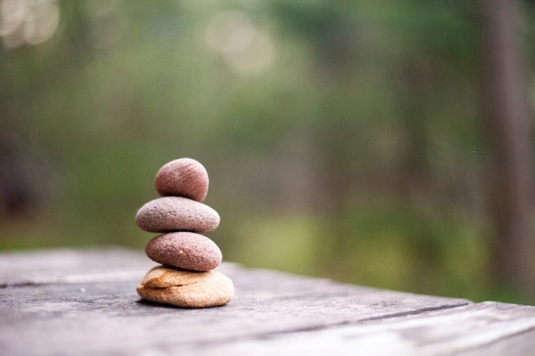 rocks stacked on a wood table
